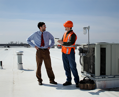 HVAC technician and customer laughing