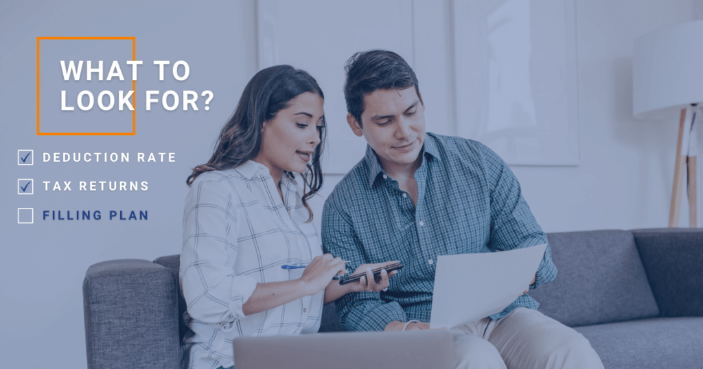 a couple on couch looking at document with text 'what to look for'